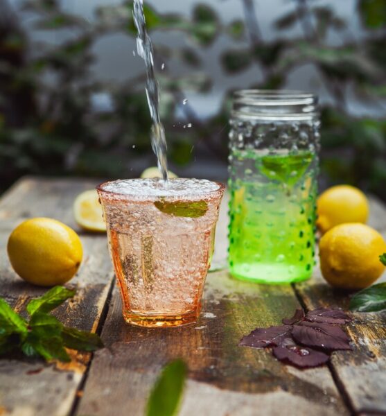 lemonade-ingredients-glass-jar-wooden-yard-table-side-view_176474-5970